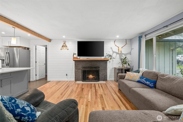 8207 Woodbourne Dr SW, Lakewood, WA 98499 - living area with recessed lighting, a fireplace, light wood-style floors, and beamed ceiling