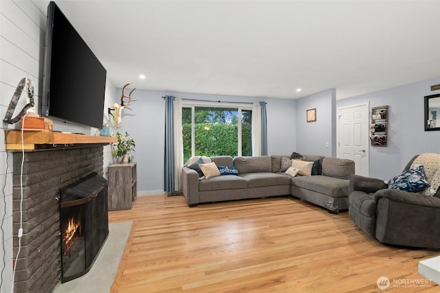 8207 Woodbourne Dr SW, Lakewood, WA 98499 - living area with recessed lighting, a brick fireplace, and light wood-type flooring