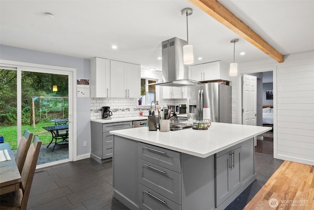 8207 Woodbourne Dr SW, Lakewood, WA 98499 - kitchen with island range hood, gray cabinets, a healthy amount of sunlight, and appliances with stainless steel finishes