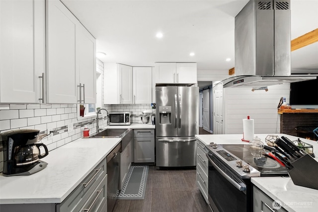 8207 Woodbourne Dr SW, Lakewood, WA 98499 - kitchen featuring stainless steel appliances, gray cabinetry, island range hood, and decorative backsplash