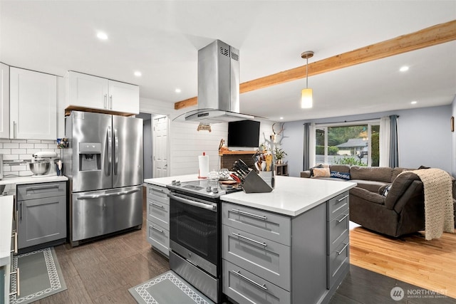 8207 Woodbourne Dr SW, Lakewood, WA 98499 - kitchen with island exhaust hood, gray cabinets, light countertops, white cabinets, and stainless steel appliances