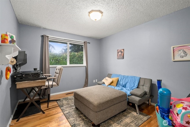 8207 Woodbourne Dr SW, Lakewood, WA 98499 - bedroom featuring wood finished floors and a textured ceiling