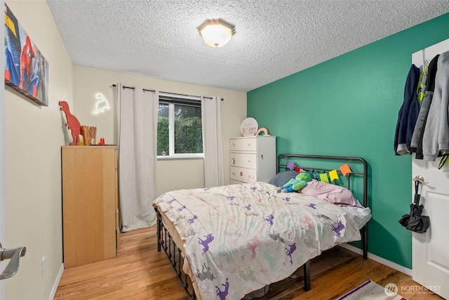 8207 Woodbourne Dr SW, Lakewood, WA 98499 - bedroom featuring wood finished floors and a textured ceiling