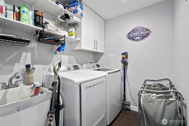 8207 Woodbourne Dr SW, Lakewood, WA 98499 - clothes washing area featuring dark wood-type flooring, washing machine and dryer, a sink, and cabinet space