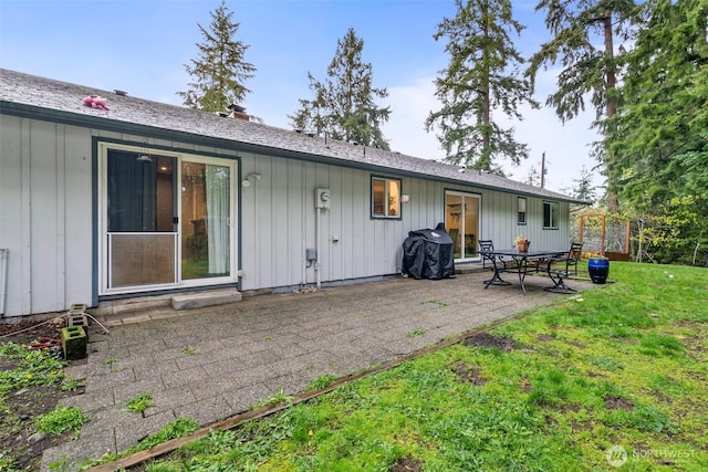 8207 Woodbourne Dr SW, Lakewood, WA 98499 - back of property with a patio, a yard, board and batten siding, and a chimney