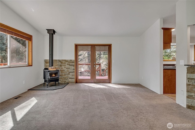 28529 298th Pl SE, Ravensdale, WA 98051 - unfurnished living room with a healthy amount of sunlight, a wood stove, and visible vents