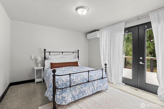 bedroom featuring french doors, a wall mounted AC, baseboards, and visible vents