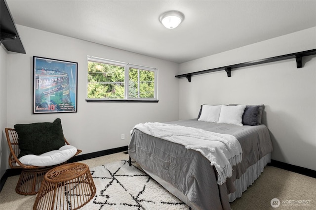 bedroom featuring light colored carpet and baseboards