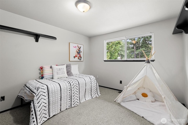 bedroom featuring carpet floors and baseboards