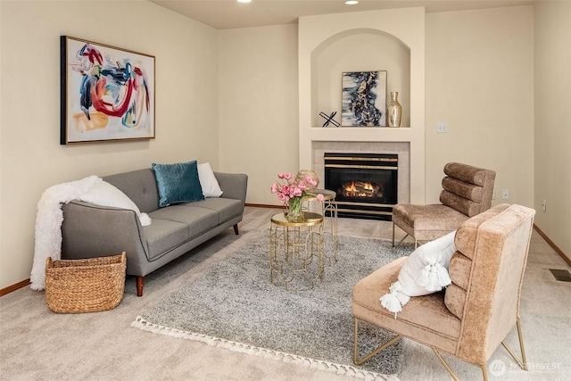 living area with baseboards, recessed lighting, a tiled fireplace, carpet flooring, and visible vents