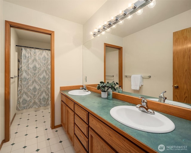 full bathroom featuring double vanity, a sink, and curtained shower