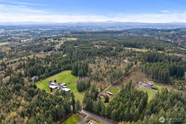 aerial view with a wooded view and a mountain view