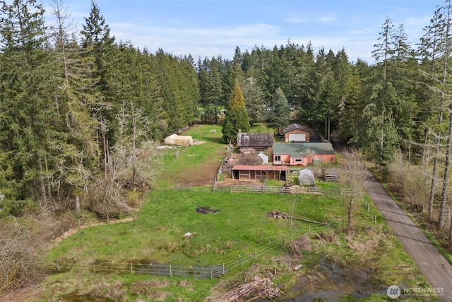 birds eye view of property featuring a wooded view