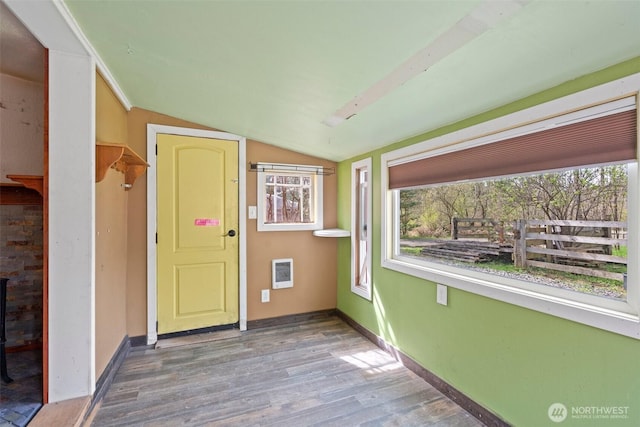 unfurnished sunroom with heating unit