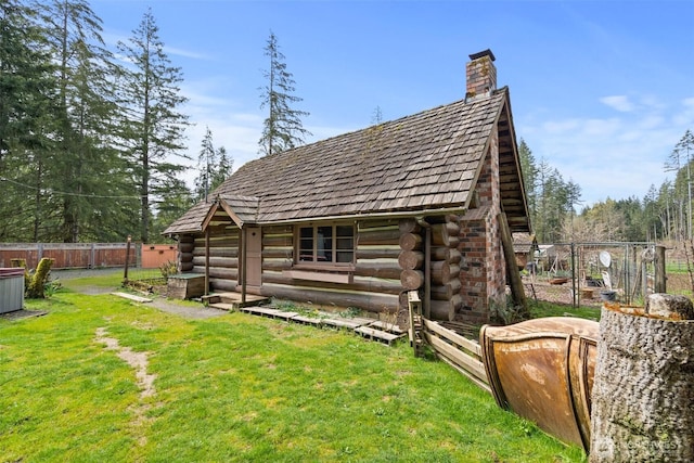 view of outdoor structure with an outbuilding and fence