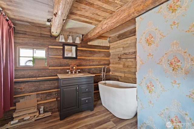 bathroom featuring a freestanding tub, vanity, beam ceiling, wood ceiling, and wood finished floors