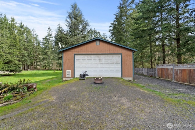 detached garage featuring fence