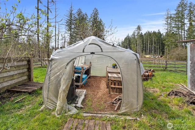 view of outdoor structure with an outbuilding and fence