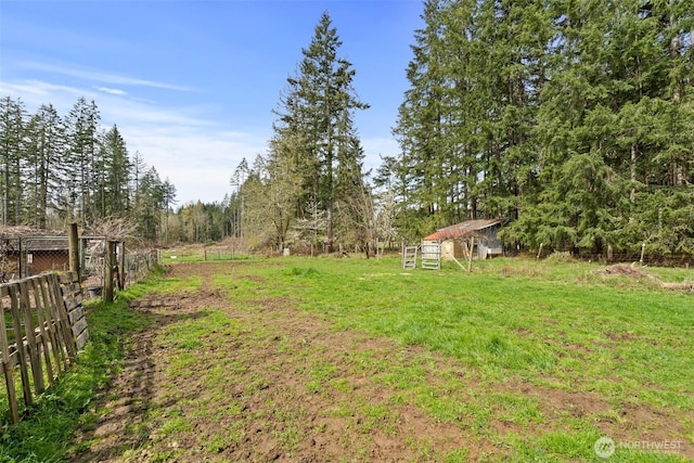 view of yard featuring fence and an outdoor structure