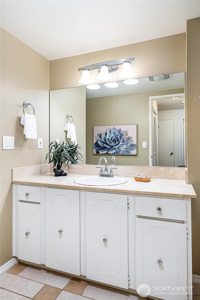 bathroom featuring vanity and baseboards