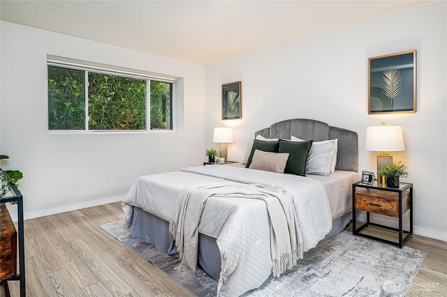 bedroom featuring wood finished floors and baseboards