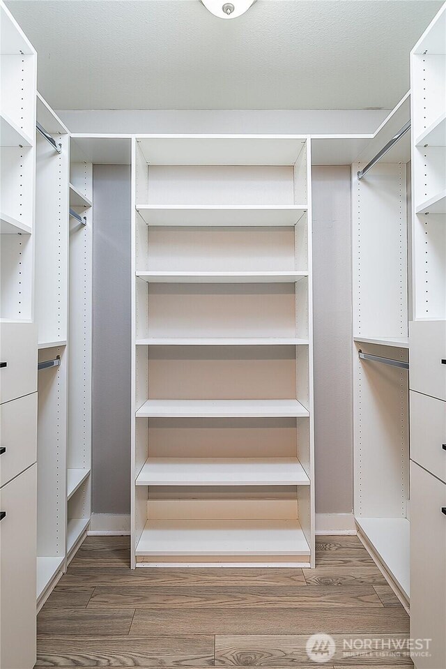 spacious closet with wood finished floors