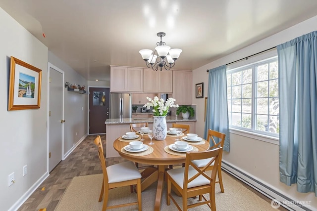 291 C St SE, Ephrata, WA 98823 - dining area with baseboard heating, a chandelier, baseboards, and dark wood-style floors