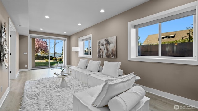 living room featuring baseboards, wood finished floors, and recessed lighting
