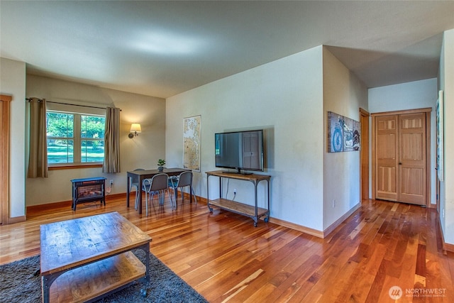 living room featuring wood finished floors and baseboards