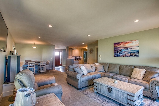 carpeted living area featuring baseboards and recessed lighting