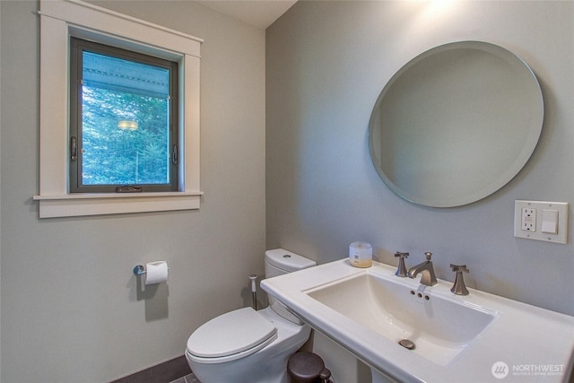half bath with toilet and a sink