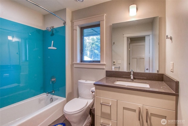bathroom featuring toilet, vanity, and tub / shower combination