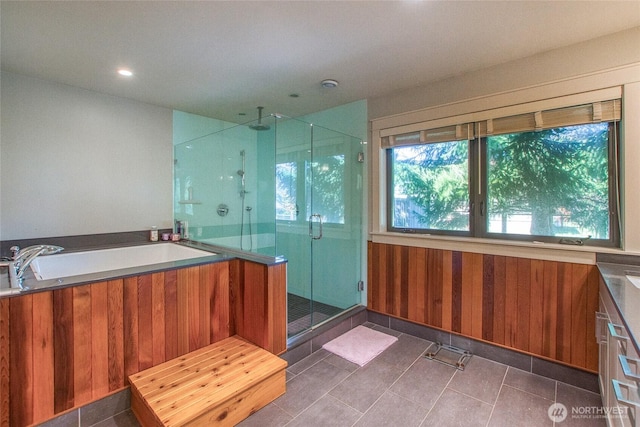 full bath with a shower stall, tile patterned floors, a bath, and a sink