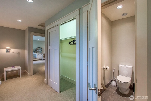 bathroom with toilet, recessed lighting, and baseboards