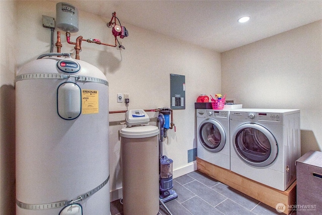 washroom with dark tile patterned flooring, laundry area, washing machine and clothes dryer, and recessed lighting