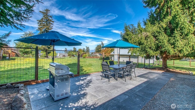 view of patio / terrace featuring grilling area, fence, and outdoor dining area