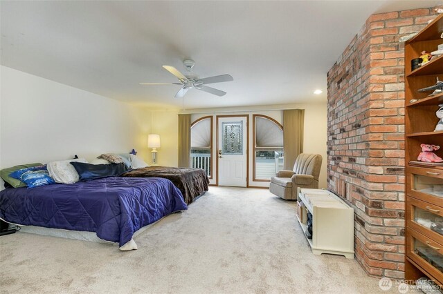 carpeted bedroom featuring access to outside and a ceiling fan