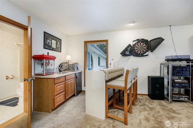 dining room with baseboards and light colored carpet