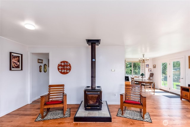 790 N Rhodefer Rd, Sequim, WA 98382 - living room with a wood stove, a notable chandelier, and light wood-type flooring