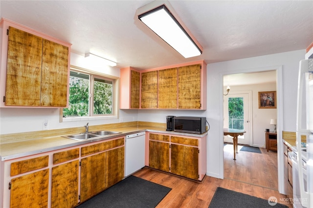 790 N Rhodefer Rd, Sequim, WA 98382 - kitchen featuring stainless steel microwave, light countertops, dishwasher, a sink, and light wood-type flooring