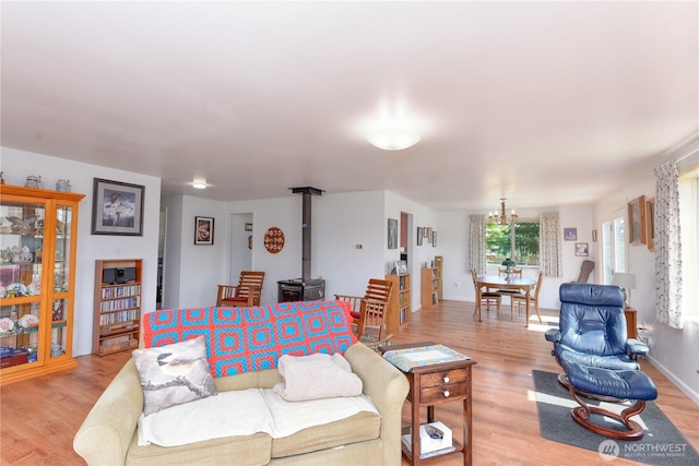 790 N Rhodefer Rd, Sequim, WA 98382 - living room with an inviting chandelier, light wood-type flooring, and a wood stove