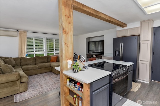 kitchen featuring light countertops, open floor plan, dark wood-style floors, and stainless steel electric range oven