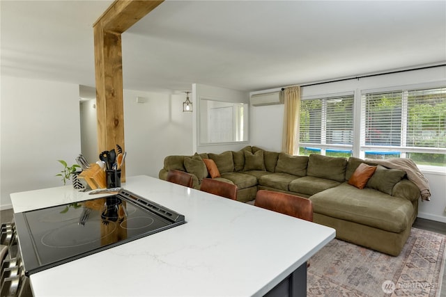 living room with an AC wall unit and light wood-style flooring