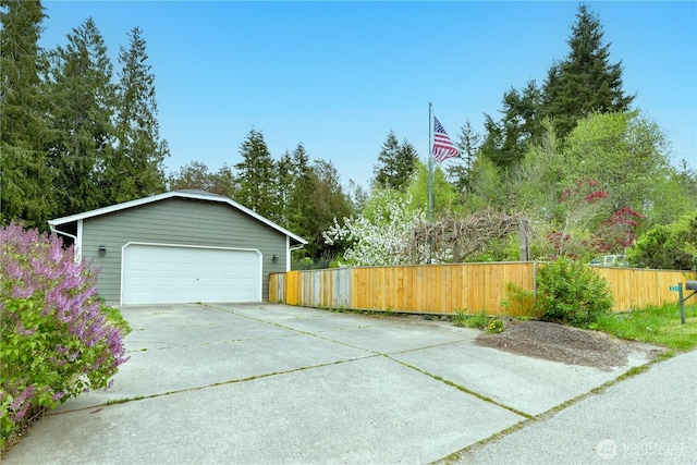 detached garage featuring fence
