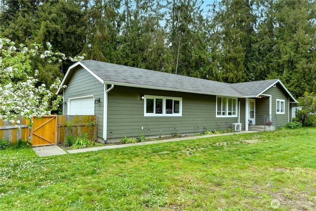 ranch-style home with a garage, a front lawn, fence, a gate, and a shingled roof