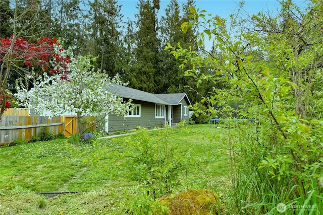 view of yard with fence and a trampoline
