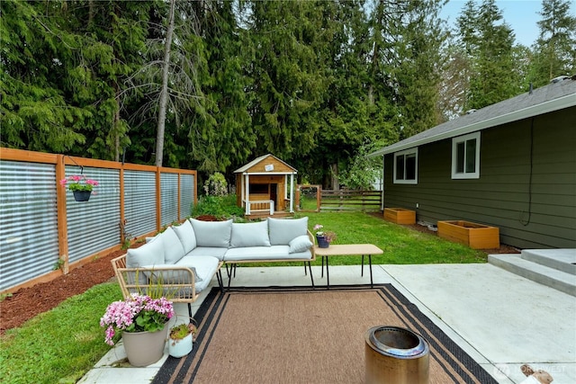 view of patio / terrace with a fenced backyard, an outdoor structure, and outdoor lounge area