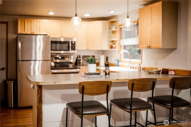 139 Mount Rainier Dr, Packwood, WA 98361 - kitchen with a peninsula, appliances with stainless steel finishes, pendant lighting, and a kitchen breakfast bar