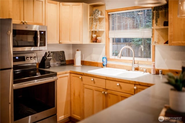 139 Mount Rainier Dr, Packwood, WA 98361 - kitchen featuring open shelves, a sink, light countertops, light brown cabinetry, and stainless steel appliances