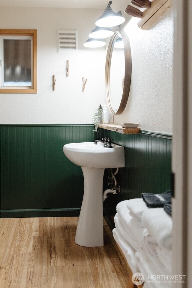 139 Mount Rainier Dr, Packwood, WA 98361 - bathroom with visible vents, a wainscoted wall, and wood finished floors